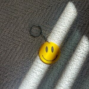 brandy melville yellow and black smiley face keychain